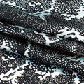 A folded sample of Metallic Reef Hologram Spandex Fabric in the color Black/Silver
