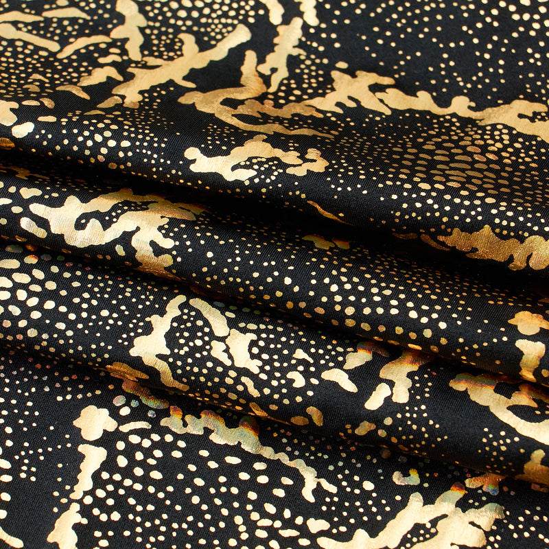 A folded sample of Metallic Reef Hologram Spandex Fabric in the color Black/Gold