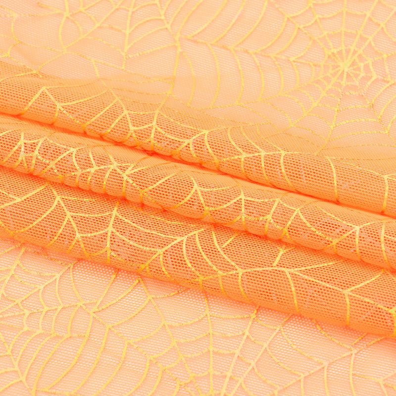 A folded sample of Spiderweb Foiled Mesh Spandex Fabric in the color Orange/Gold