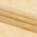 A folded sample of Spiderweb Foiled Mesh Spandex Fabric in the color Skin/Gold