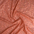 A swirled sample of zsa spa spandex sequin in the color coral.