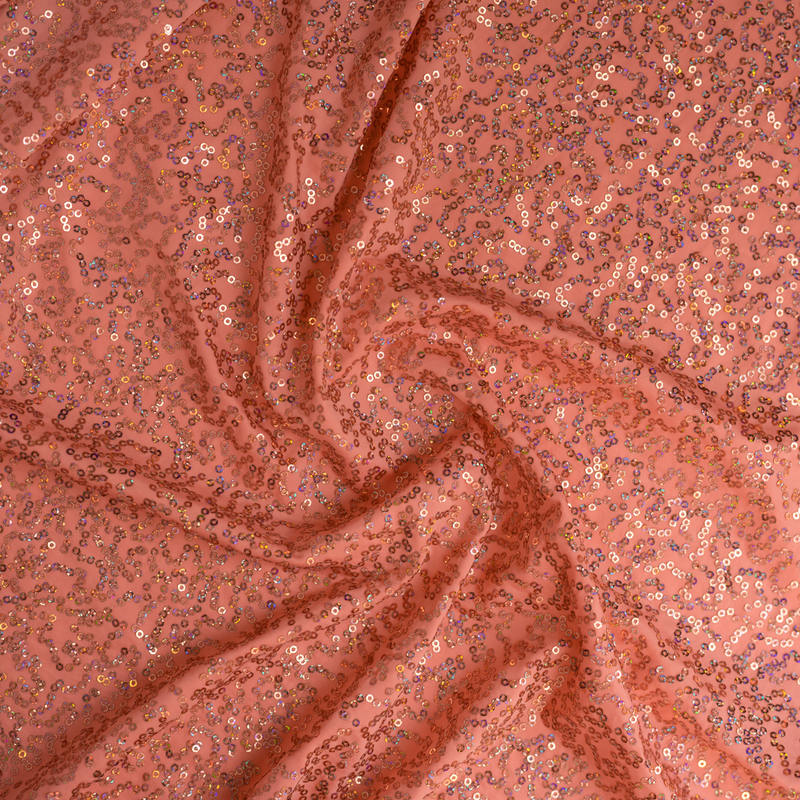 A swirled sample of zsa spa spandex sequin in the color coral.