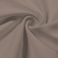 A swirled piece of Synergy Polyester Lycra in the color Taupe