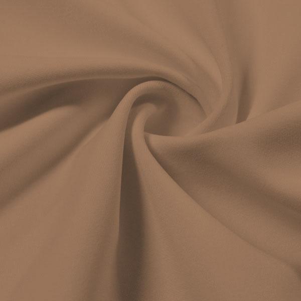 A swirled piece of Synergy Polyester Lycra in the color Honey Beige