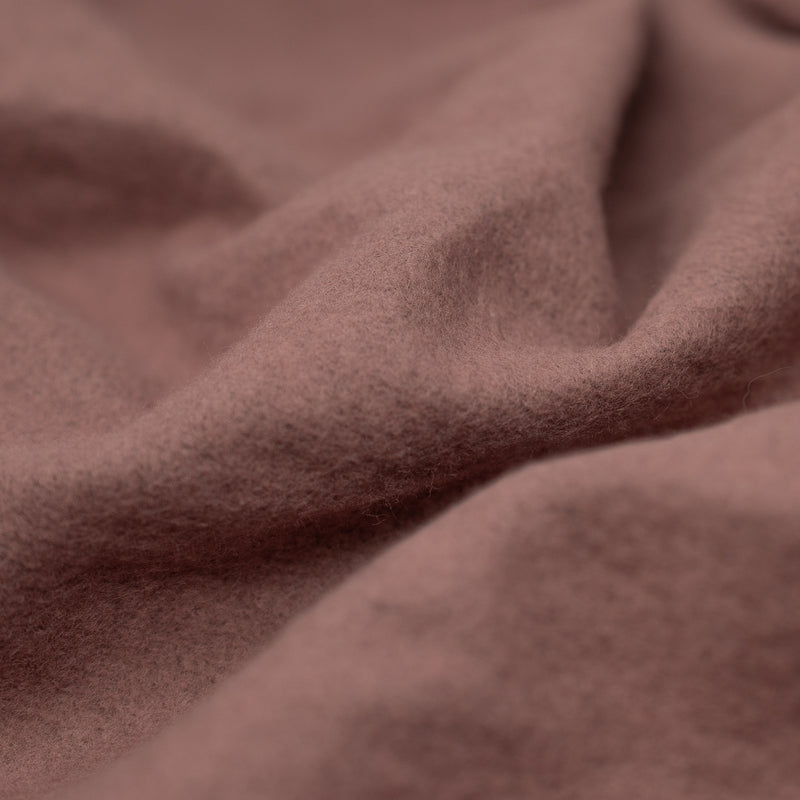 A crumpled piece of Cloud 9 Foil Printed Brushed Terry Fleece in the color Mauve/Rose Gold