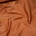 A detailed shot of Venom Shiny Look Spandex fabric with an all over shiny look in the color Copper.