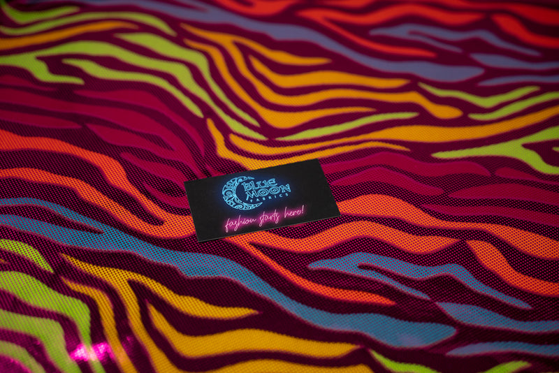Detailed photograph of Fantastic Fever Foiled Spandex in the color Fuchsia with a Blue Moon Fabrics standard size business card laid on top of the print for pattern sizing.