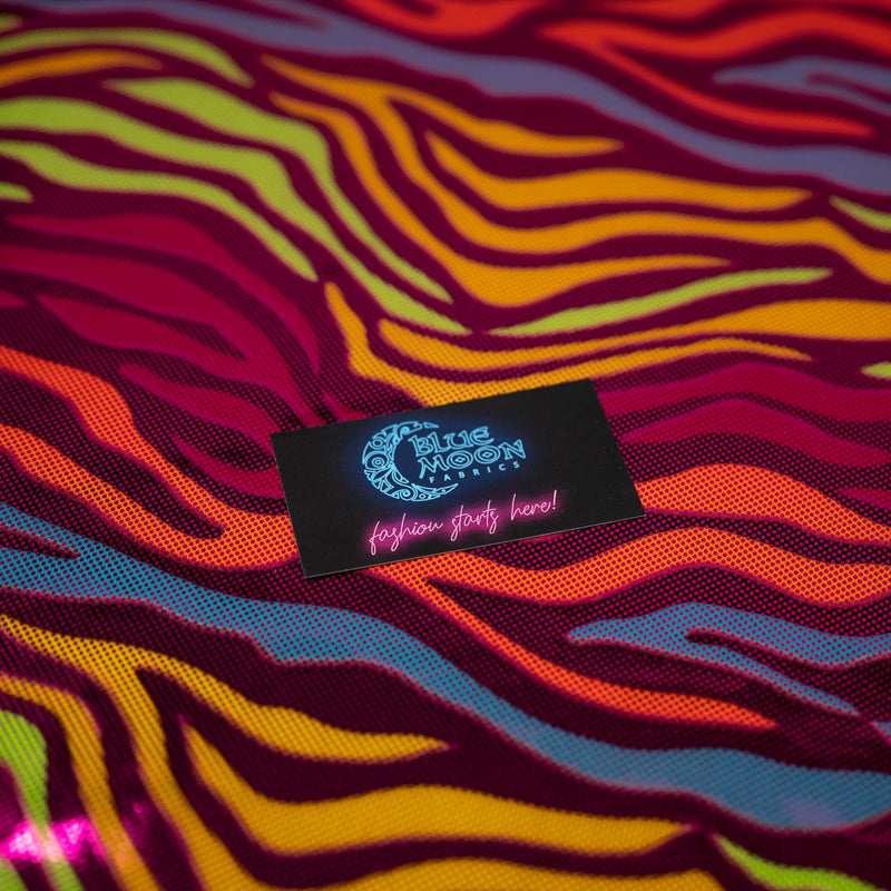 Detailed photograph of Fantastic Fever Foiled Spandex in the color Fuchsia with a Blue Moon Fabrics standard size business card laid on top of the print for pattern sizing.