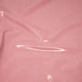 A swirled piece of polyurethane coated polyester spandex in the color Blush