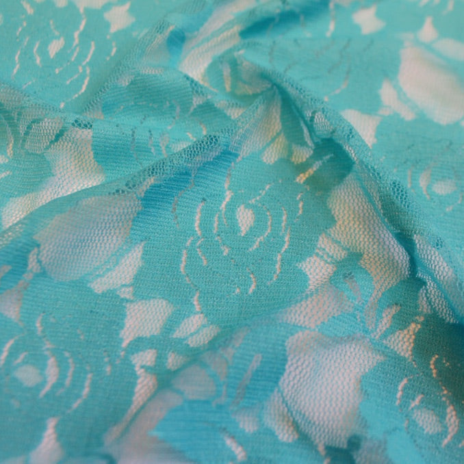 A swirled sample of Ada Stretch Lace in the color Turquoise.