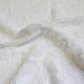 A swirled sample of Ada Stretch Lace in the color white.