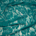 A swirled sample of Ada Stretch Lace in the color Dark Turquoise.