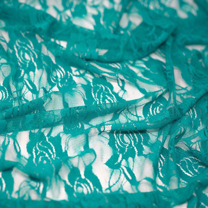 A swirled sample of Ada Stretch Lace in the color Peacock.