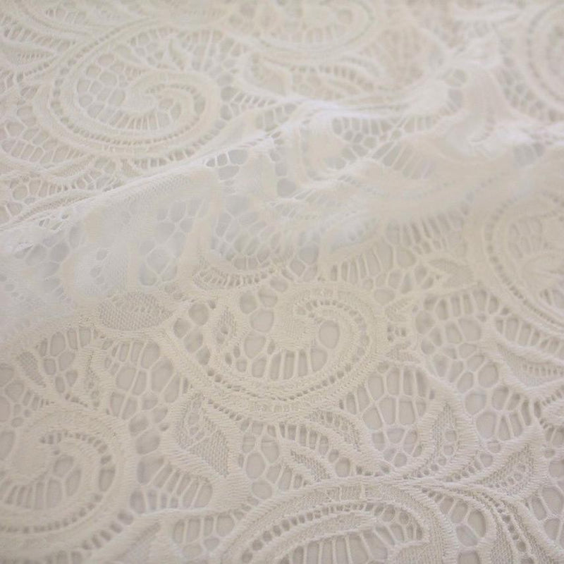 A flat sample of Adelaide stretch lace in the color white.