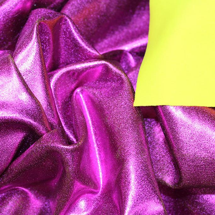 A crumpled piece of Alloy Foiled Spandex with pink foil on bumblebee spandex.