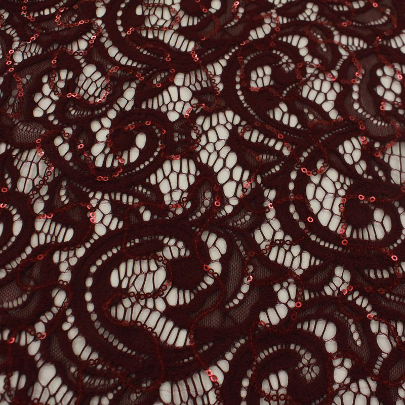 A flat sample of ashley stretch lace sequin in the color burgundy.