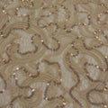 A flat sample of ashlet stretch lace sequin in the color nude.