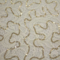 A flat sample of ashley stretch lace sequin in the color off-white.