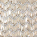 A flat sample of athena embroidered mesh sequin in the color champagne.