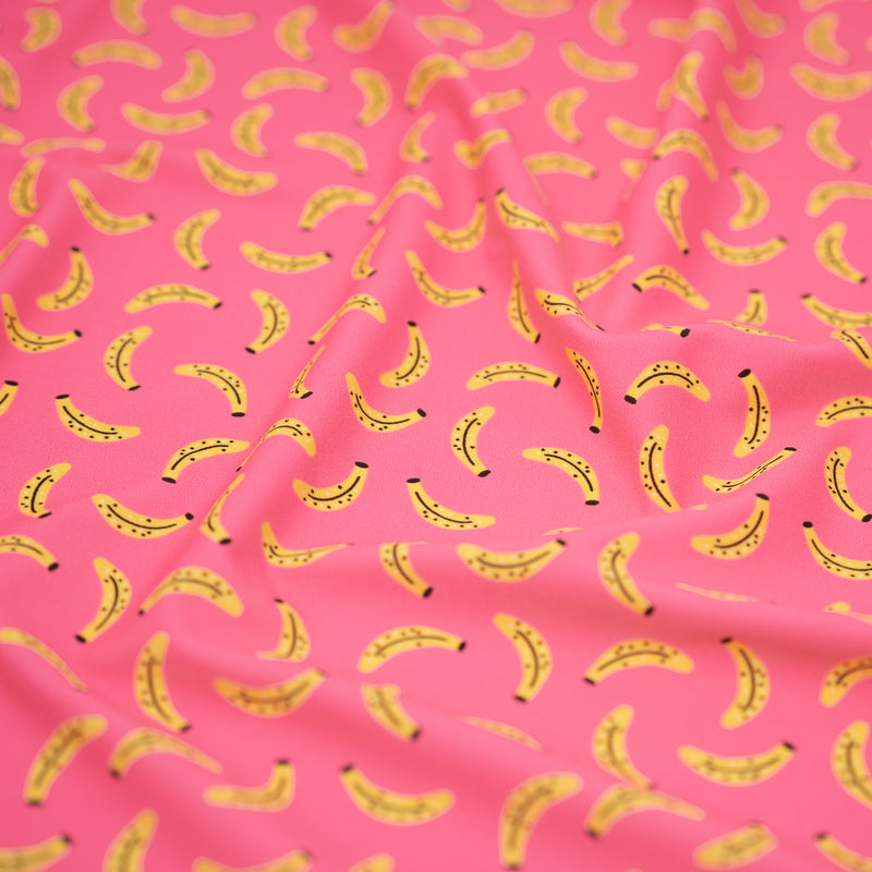 A crumpled piece of Bananas on Pink Printed Spandex Fabric