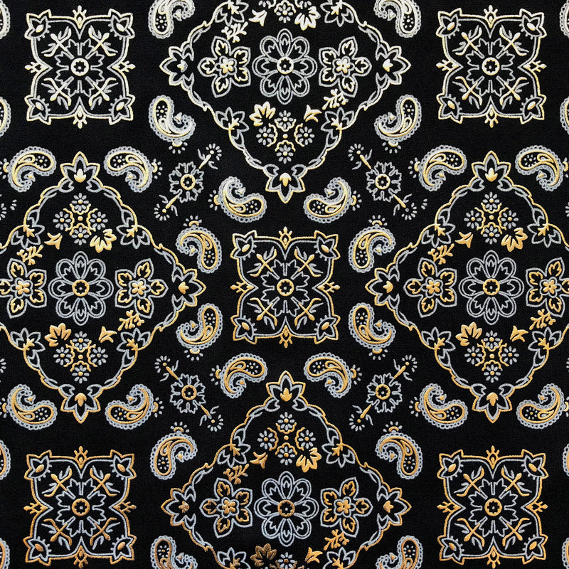 A flat sample of bandana foil prtined spandex in the color black-gold.