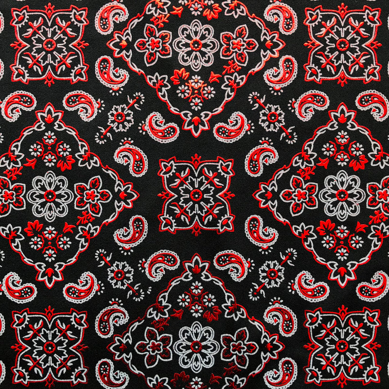 A flat sample of bandana foil printed spandex in the color black-red.