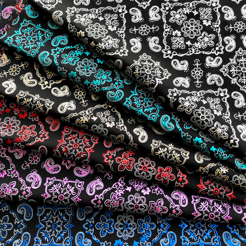 A folded sample of all colors available in bandana foil printed spandex.