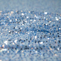A crumpled piece of Belle stretch mesh sequin in the color light blue.