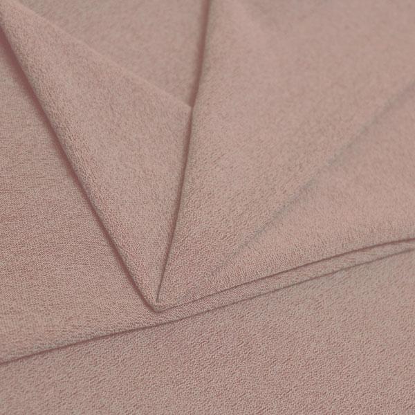 A folded piece of Blast Textured Spandex in rosy peach.