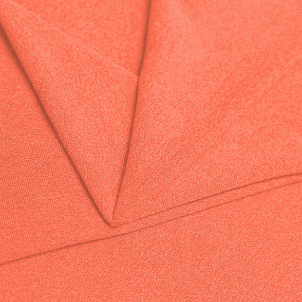 A folded piece of Blast Textured Spandex in Coral