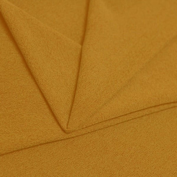 A folded piece of Blast Textured Spandex in Honey