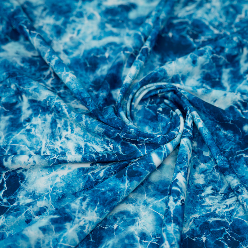 A swirled piece of Blue Magic Marble Printed Spandex