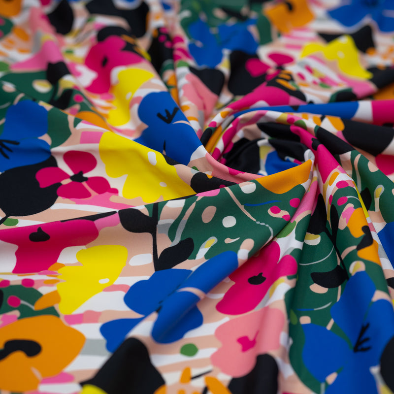 A swirled piece of Bold Tropic Floral Printed Spandex.