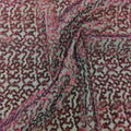 A swirled sample of caviar dreams stretch mesh sequin in the color burgundy.