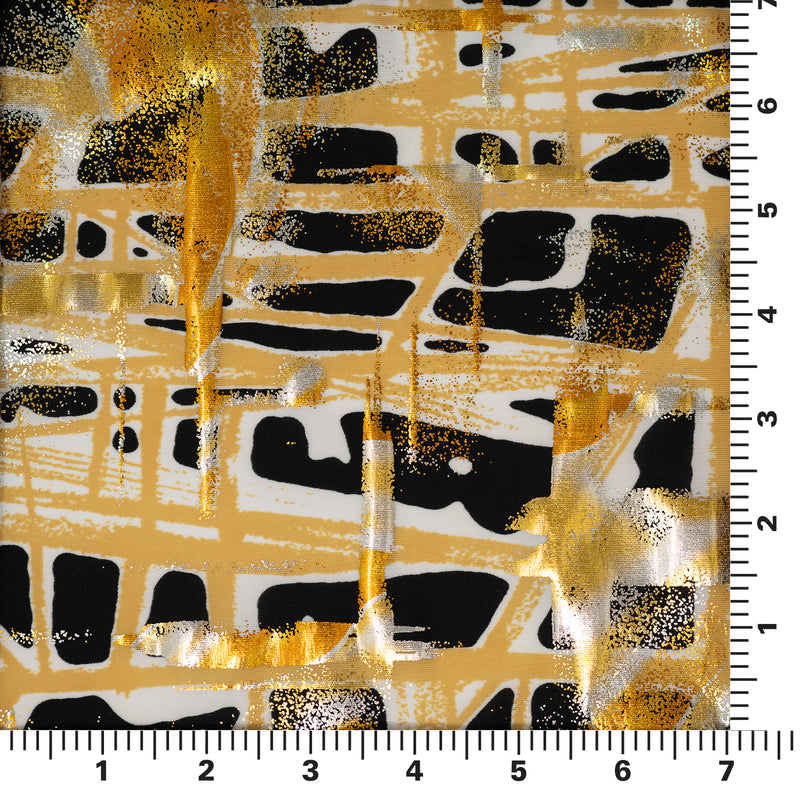 sample of cellular foil printed spandex in the color Gold with ruler to show pattern size