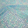 A flat sample of centerstage foiled stretch netting in the color turquoise.