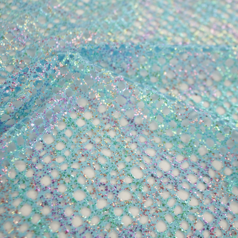 A flat sample of centerstage foiled stretch netting in the color turquoise.