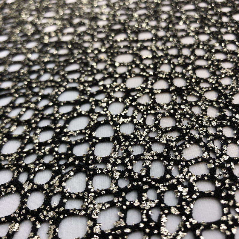 A flat sample of centerstage foiled stretch netting in the color black.