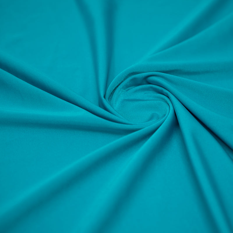 A swirled sample of Charisma shiny nylon spandex in the color Azul