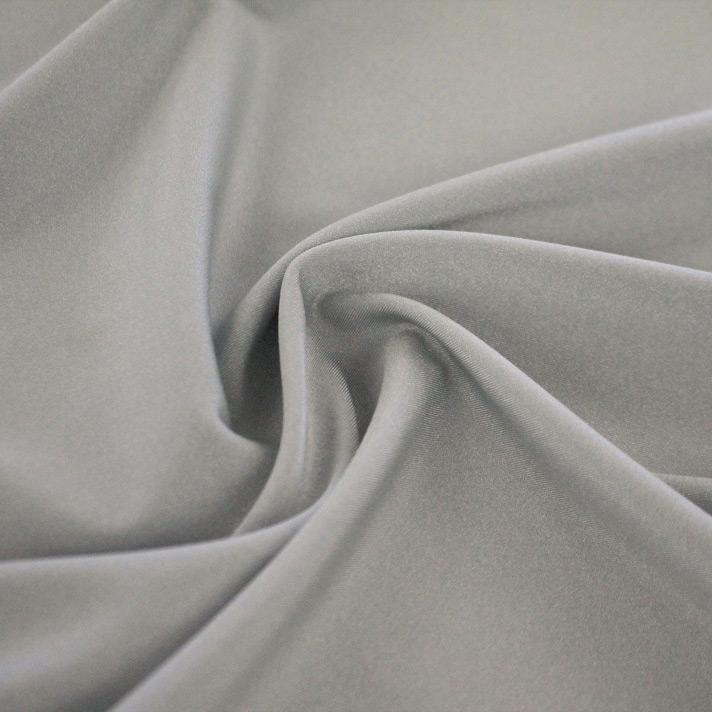 A swirled sample of Charisma shiny nylon spandex in the color silver.