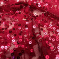 A swirled sample of charlize stretch lace sequin in the color merlot.