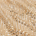 A flat sample of chequered knitted lace sequin in the color gold.