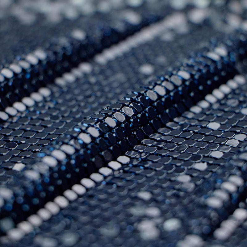 A folded sample of classic aluminum scale mesh in the color navy.