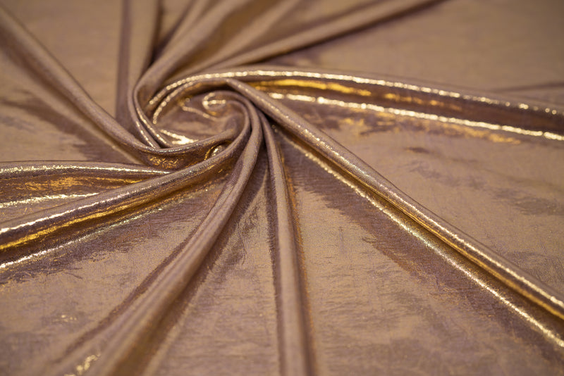 Swirled sample shot of Claudette Creased Foiled Spandex Fabric in color Mauve/Gold.