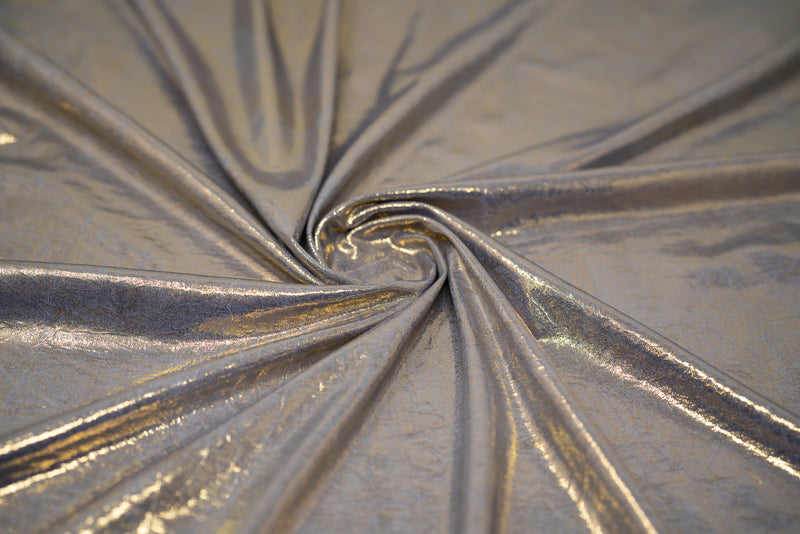 Swirled sample shot of Claudette Creased Foiled Spandex Fabric in color Periwinkle/Gold.