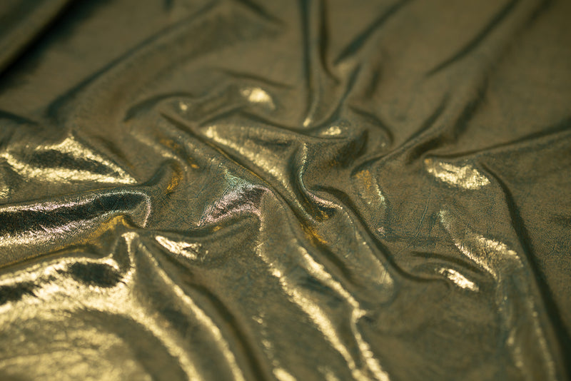 Detailed shot of Claudette Creased Foiled Spandex Fabric in color Forest-Gold