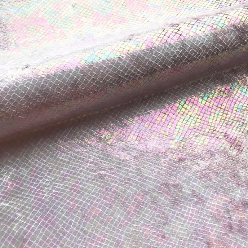 A folded sample of cobra foil printed stretch velvet in the color baby pink.