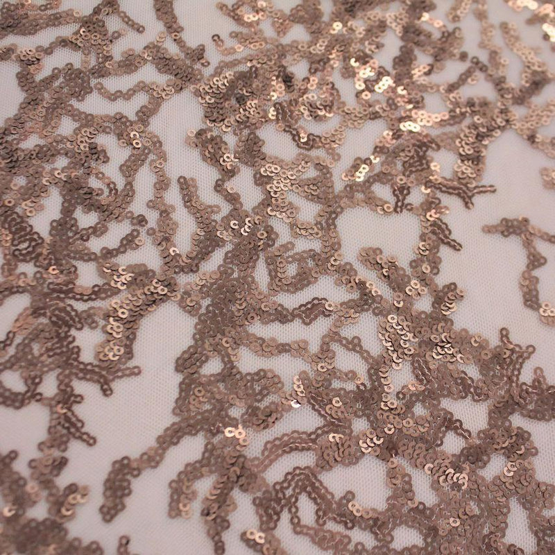 A flat sample of corla reef stretch mesh sequin in the color champagne.