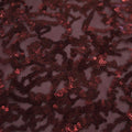 A flat sample of corla reef stretch mesh sequin in the color burgundy.
