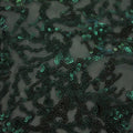A flat sample of corla reef stretch mesh sequin in the color dark green.